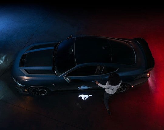 2024 Ford Mustang® Dark Horse™ model with a driver approaching the vehicle | Rydell Ford in Independence IA